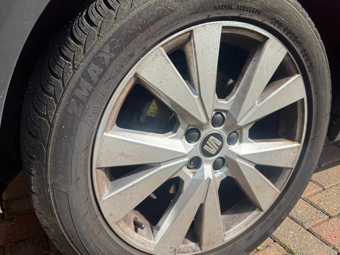 Alloy wheel before cleaning — brake dust and road grime