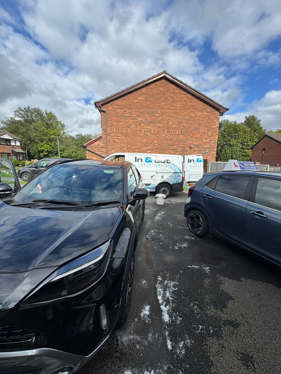 Black car dull and wet mid-wash